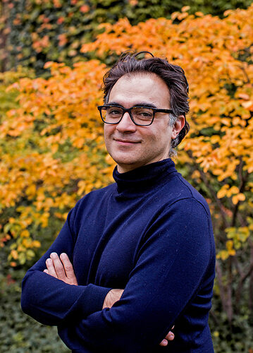 Outdoor photo of Vincenzo Vitelli in a blue turtleneck
