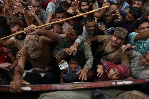 Pakistani Army soldiers distribute food following a flash flood in Hyderabad, Pakistan, on August 28.