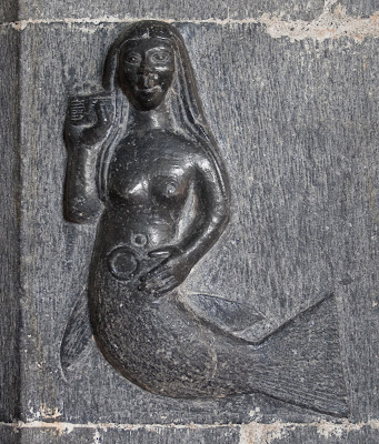 A15th-century carving of a mermaid with comb and mirror at the Clonfert Cathedral, Clonfert, County Galway, Ireland.\ 341x400